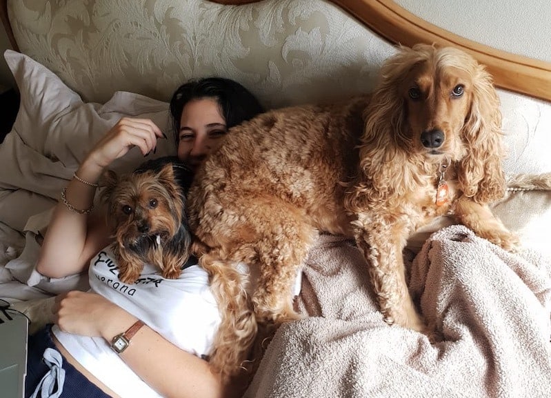 marina-sitting-on-bed-with-dogs